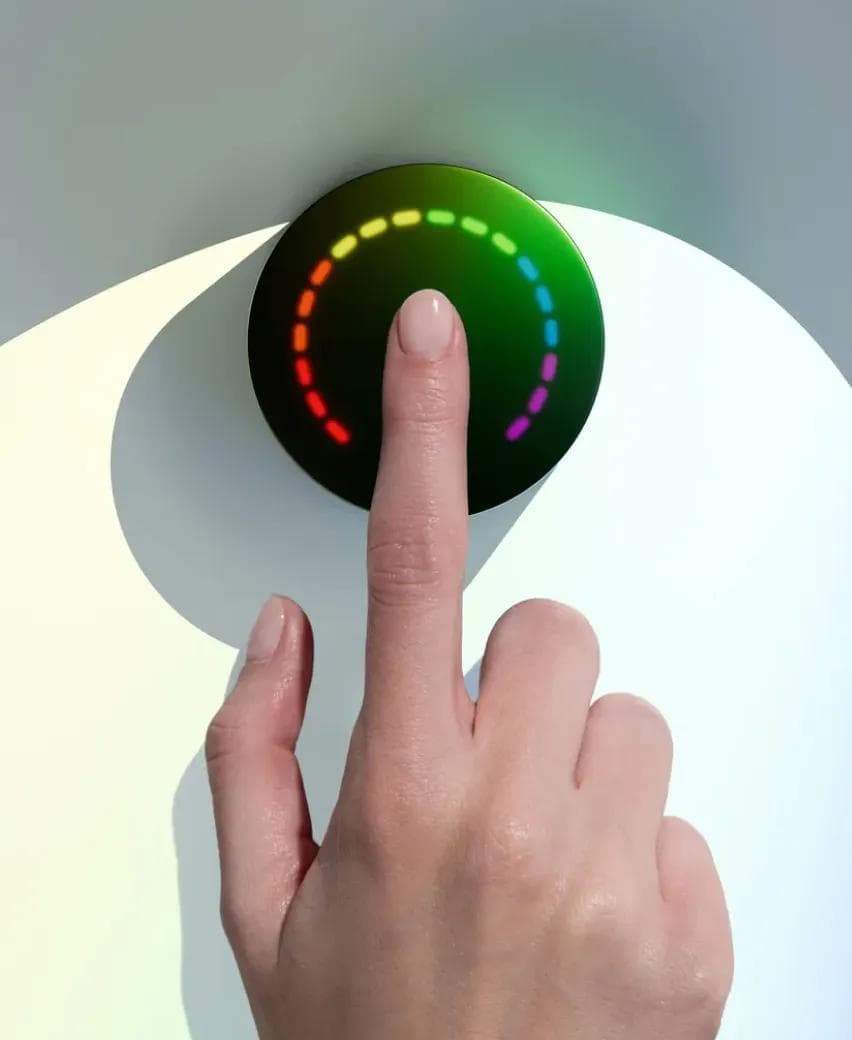 A fingertip resting on the Prysm iO scanner mid-reading